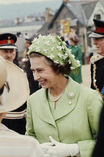 Queen Elizabeth II wearing a green jacket and beribboned hat, circa 1973. The hat is by milliner Simone Mirman. (Photo by Serge Lemoine/Getty Images)