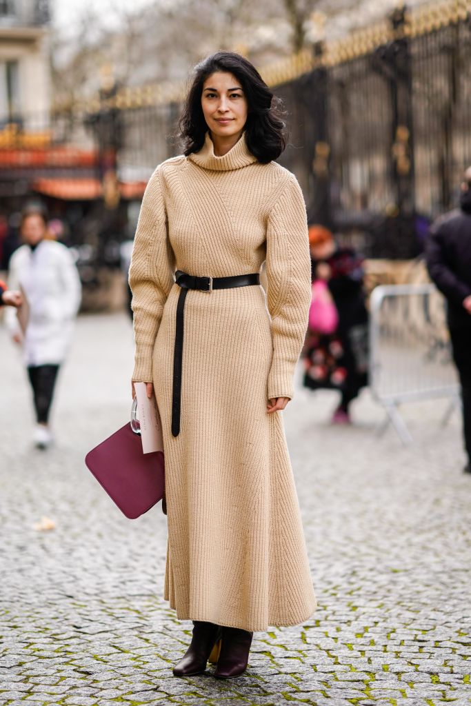 PARIS, FRANCE - MARCH 02:  Caroline Issa a beige wool dress with a turtleneck, a red bag, and attends the Nina Ricci show as part of the Paris Fashion Week Womenswear Fall/Winter 2018/2019 on March 2, 2018 in Paris, France.  (Photo by Edward Berthelot/Getty Images for Nina Ricci)